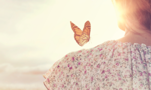 A butterfly over a girl's sholder