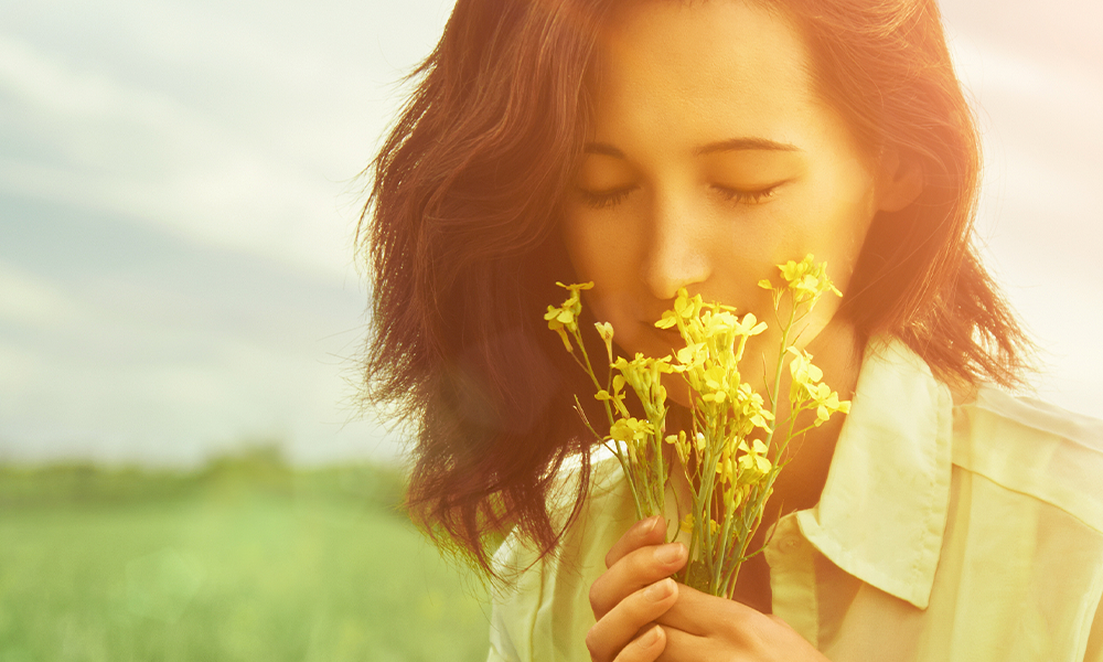 Woman smelling flowers